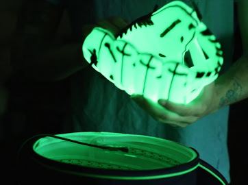 Close-up of a glowing football held above the open Chargebag charger